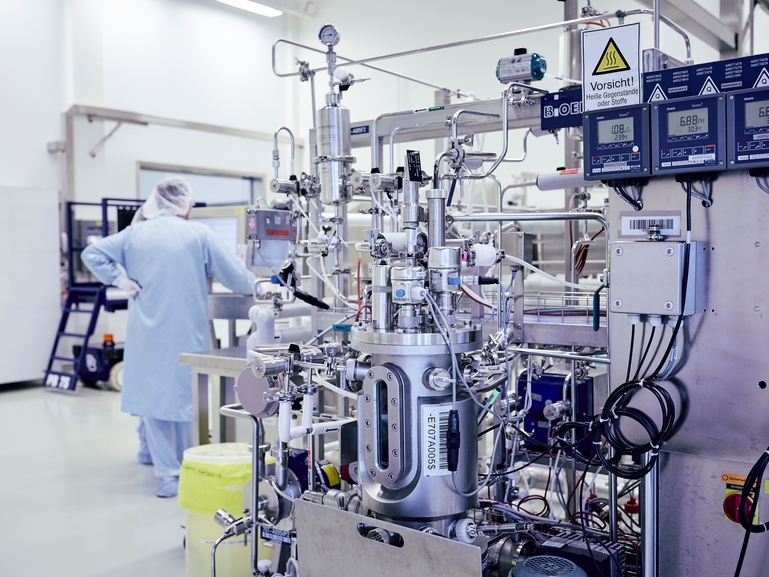 Bioreactor for the fermentation process of cell cultures with a scientist Scientist with bioreactor during the fermentation process of cell cultures for the Life Sciences