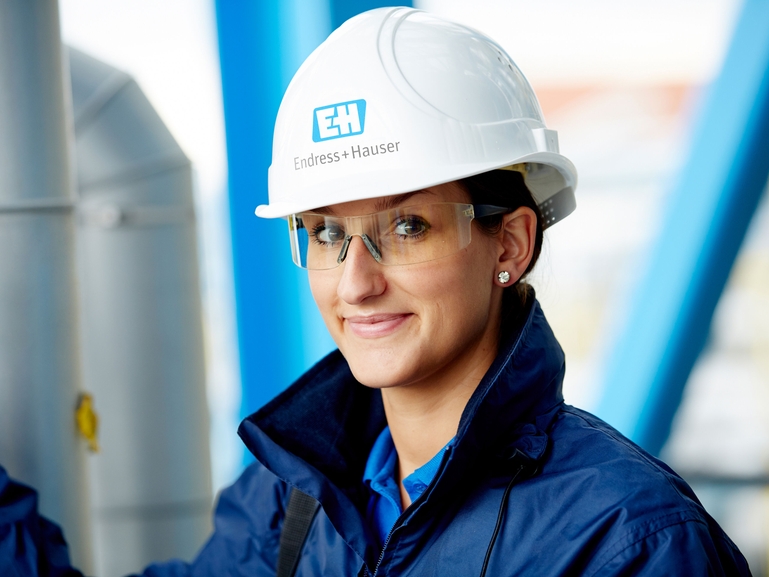 Female engineer smiling at camera.